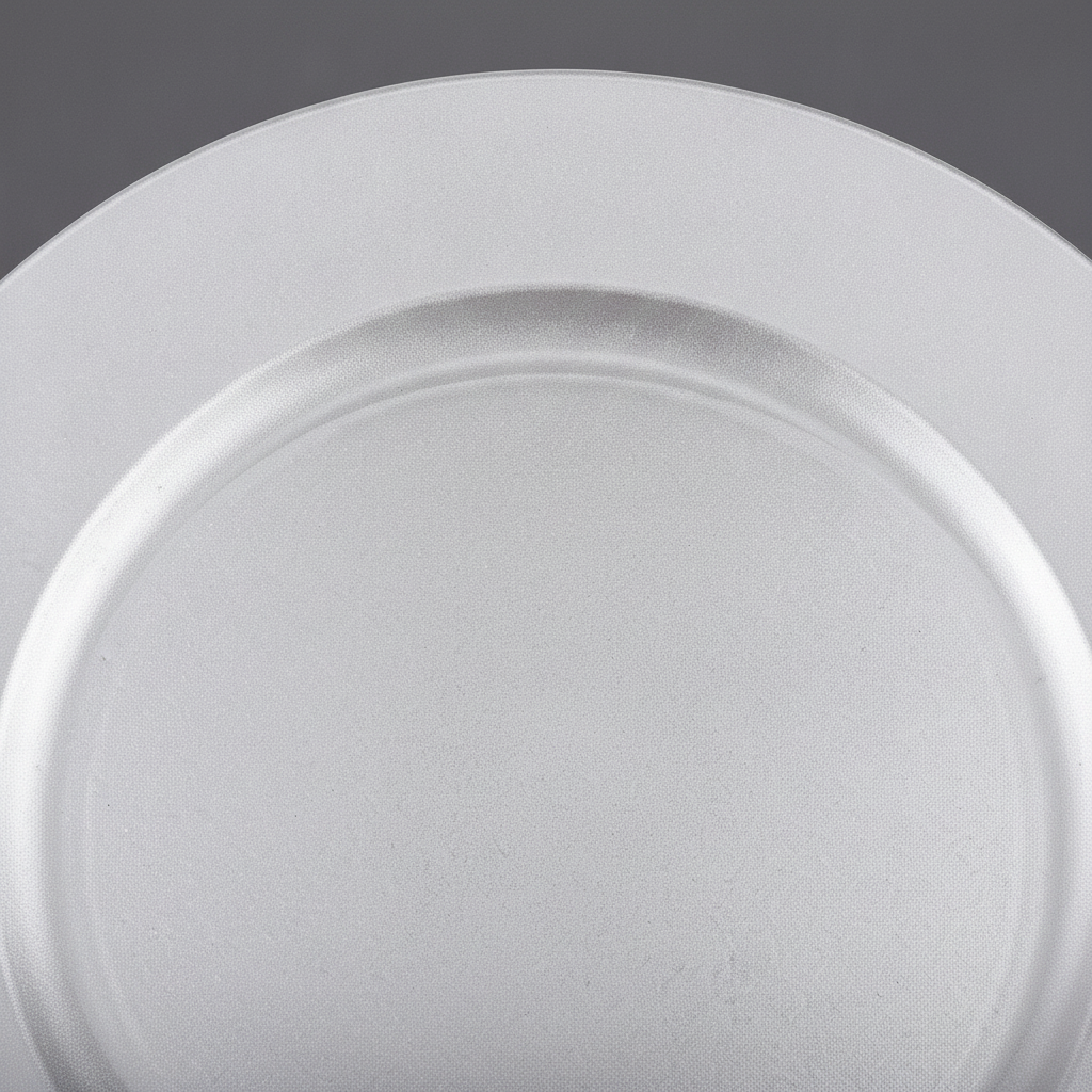Macro close-up of silver-white charger plate rim and pearl finish