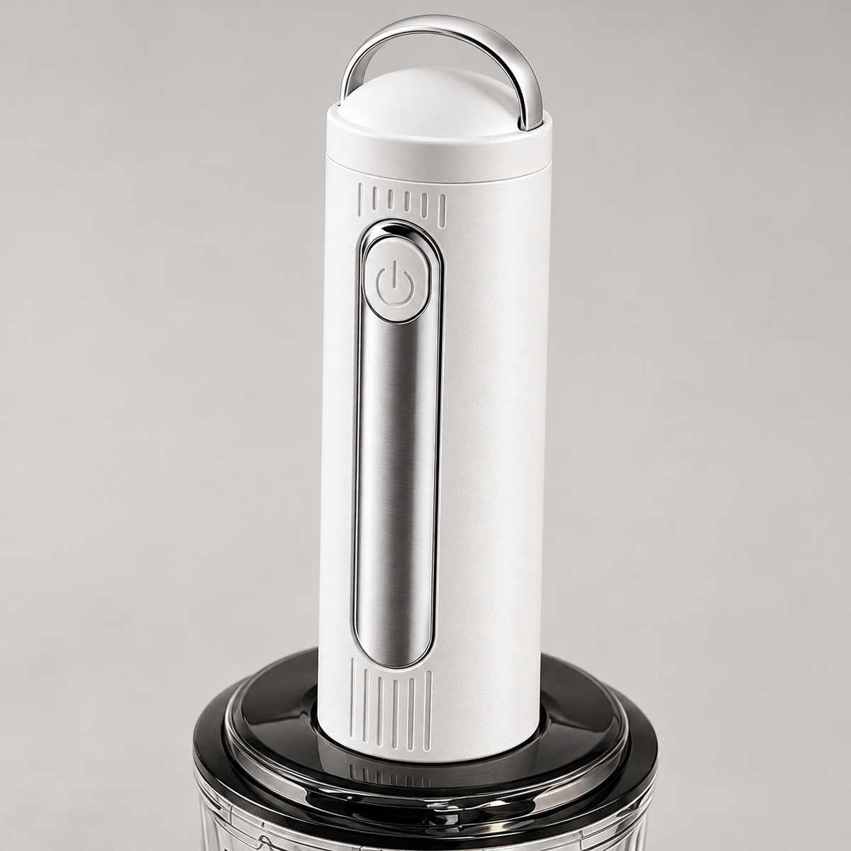 Close-up of the cordless food chopper carrying loop, power button and motor