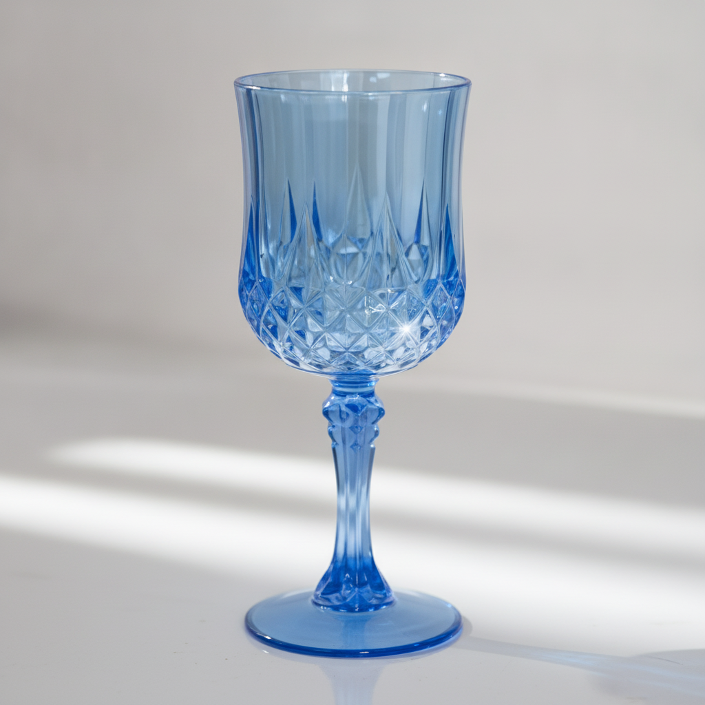 Close-up detail of the diamond-cut facets on a translucent blue plastic wine goblet