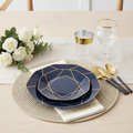 Navy blue octagonal disposable plastic plates with gold geometric trim, gold flatware and cup styled in an elegant place setting