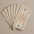 Fanned rectangular boho paper guest napkins showing the orange and cyan Persian medallion print