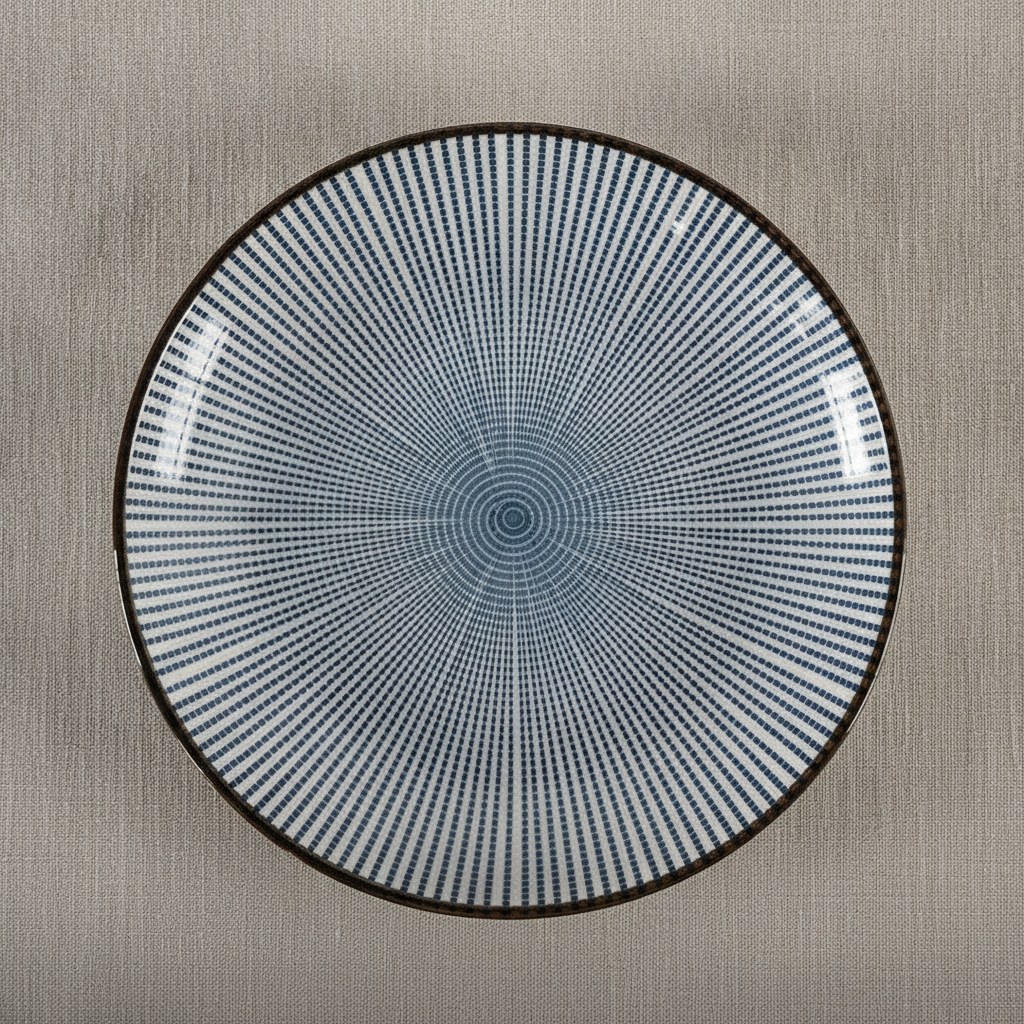 Japanese ceramic plate with blue radial line underglaze pattern and dark rim