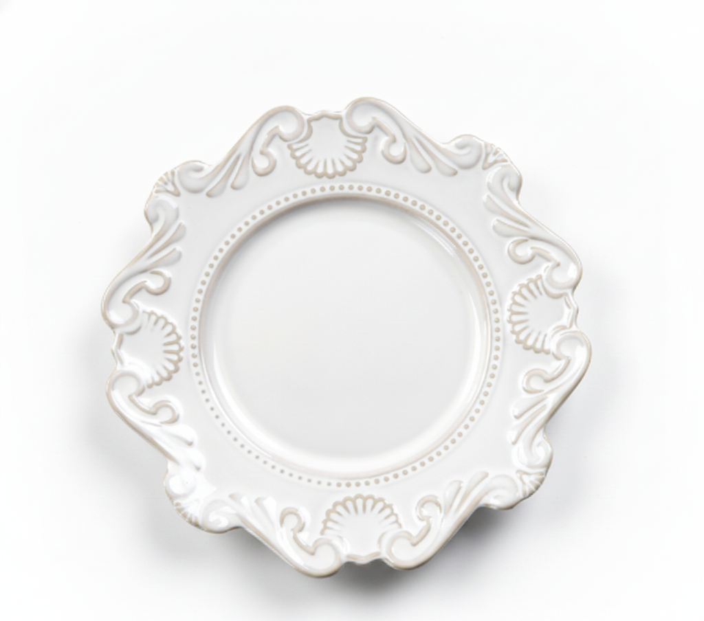 Ornate white baroque porcelain plate with scalloped relief rim on white background