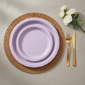 Lavender disposable paper party plates — thin matte uncoated light purple paper dinner and dessert plates on a woven rattan placemat with gold flatware and white roses