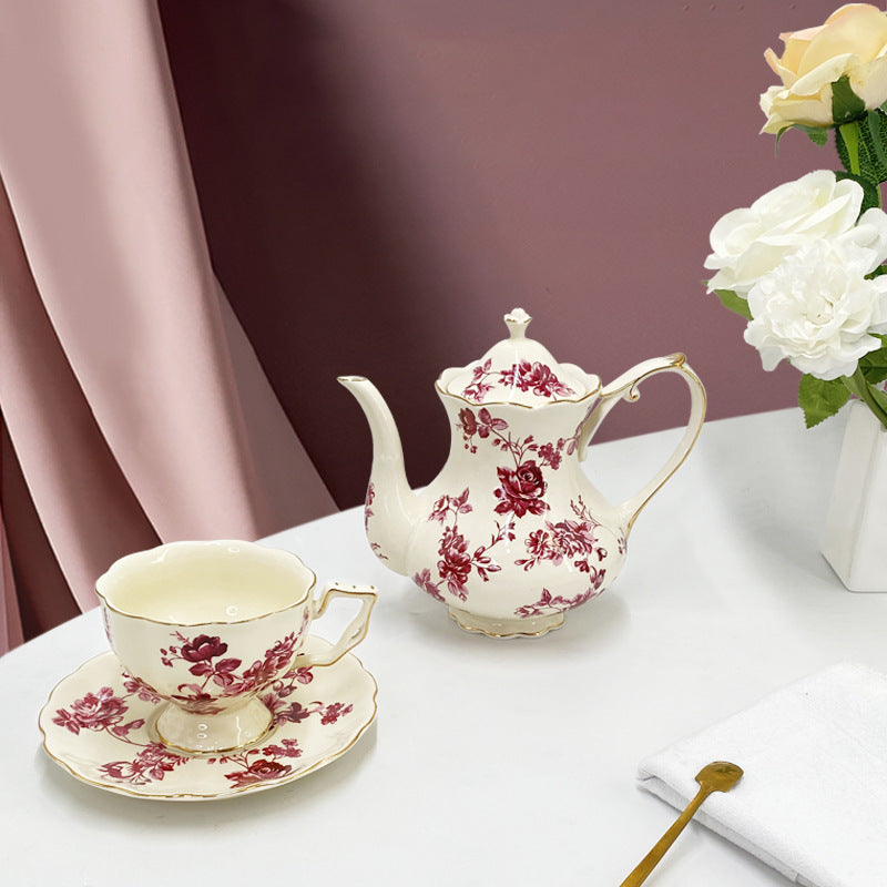 Full retro ceramic tea set flat lay: gold-trim cups, matching saucers and French teapot