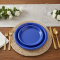 Royal blue disposable plastic dinner plates styled fine-dining place setting with gold flatware
