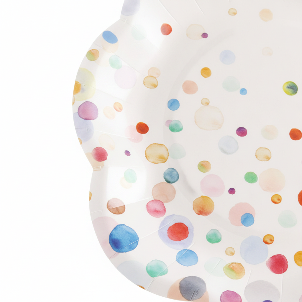 Macro close-up of colorful confetti polka-dot scalloped paper party plate