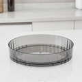 Smoke-gray rotating turntable spice organizer with generic jars, studio