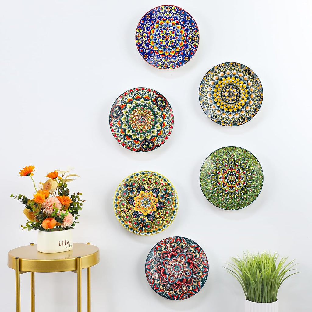 All six original mandala plate designs displayed on a wall; decor not included