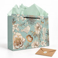 Green floral and bird gift bag with black cord handle and mint tissue – white studio