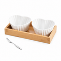 F design: two white fluted heart-shaped bowls in a wooden tray with a small two-prong fork