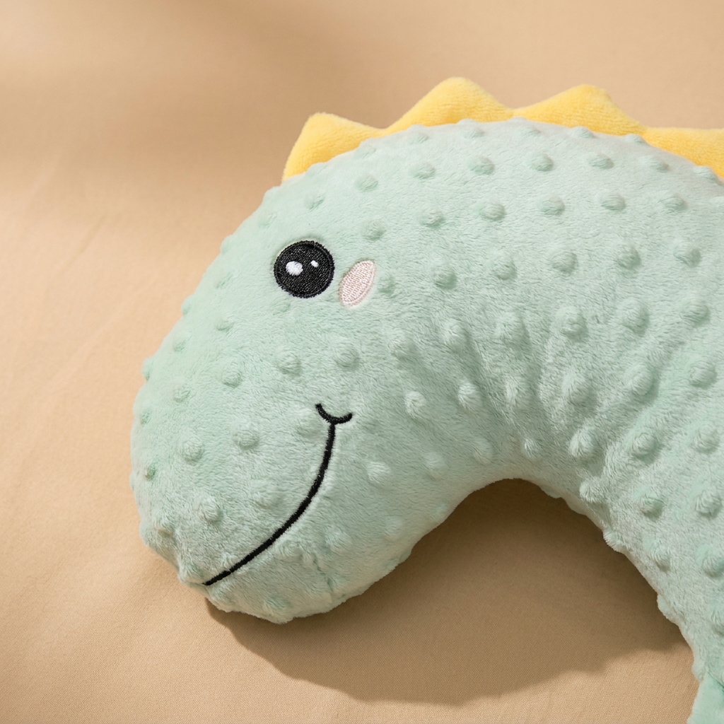 Close-up of soft dotted minky fabric on the dinosaur baby pillow