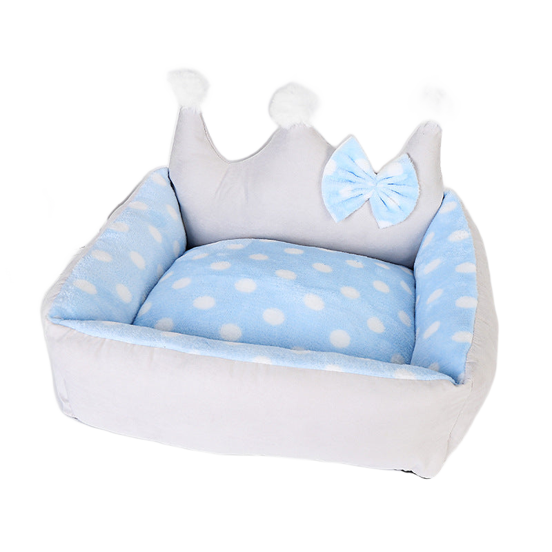 Blue crown-shaped plush dog bed on white background