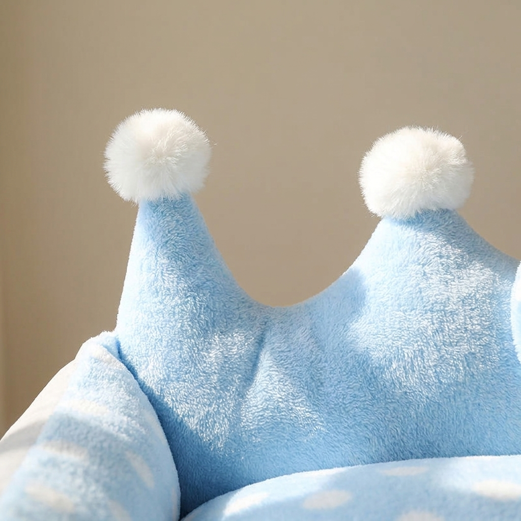 Close-up of the fleece dotted cushion and pom-pom crown detail