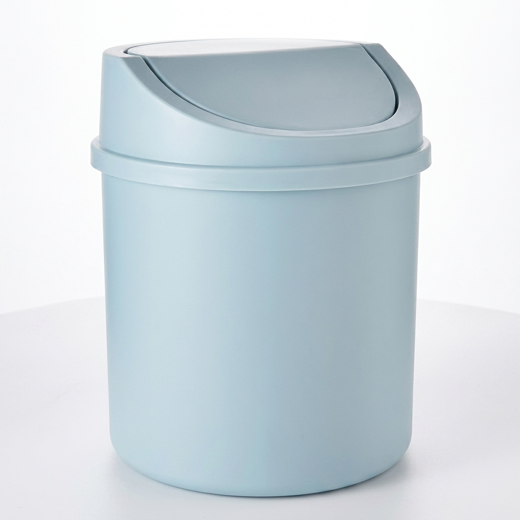 Compact blue desktop mini trash can with swing lid packshot