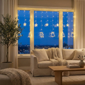 Warm white LED curtain string lights with star and Christmas charms strung across a living room window