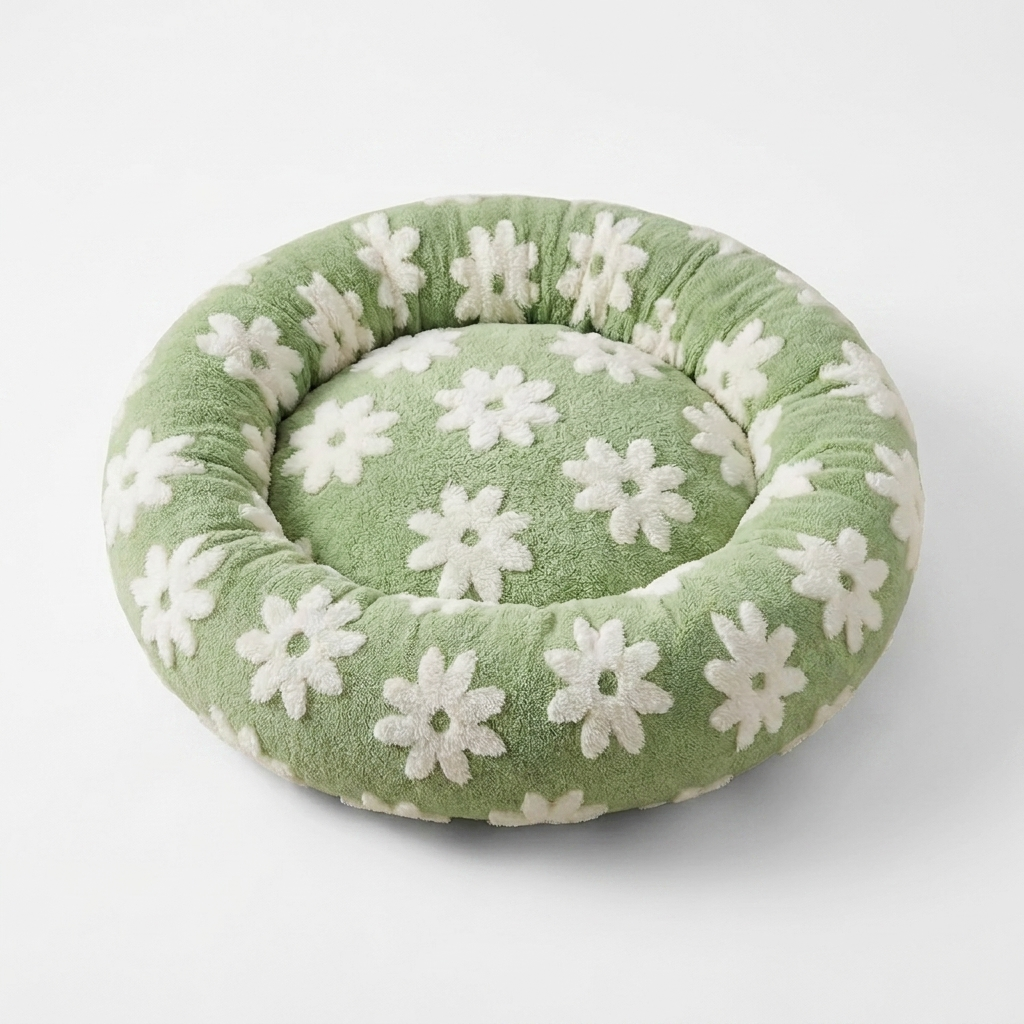 Sage green daisy-pattern donut pet bed on a clean white background
