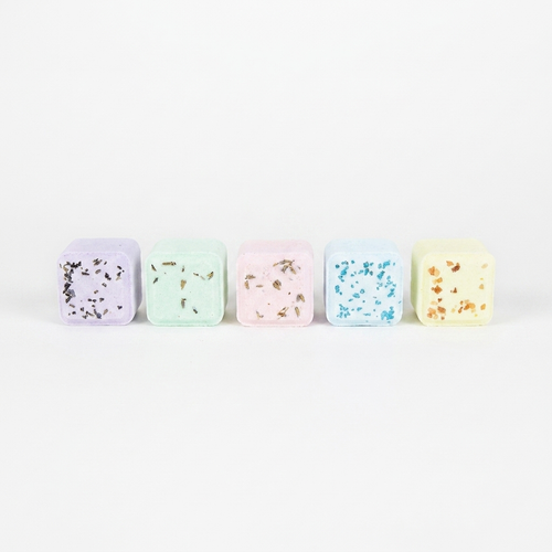 Set of 5 pastel aromatherapy shower steamers on white background