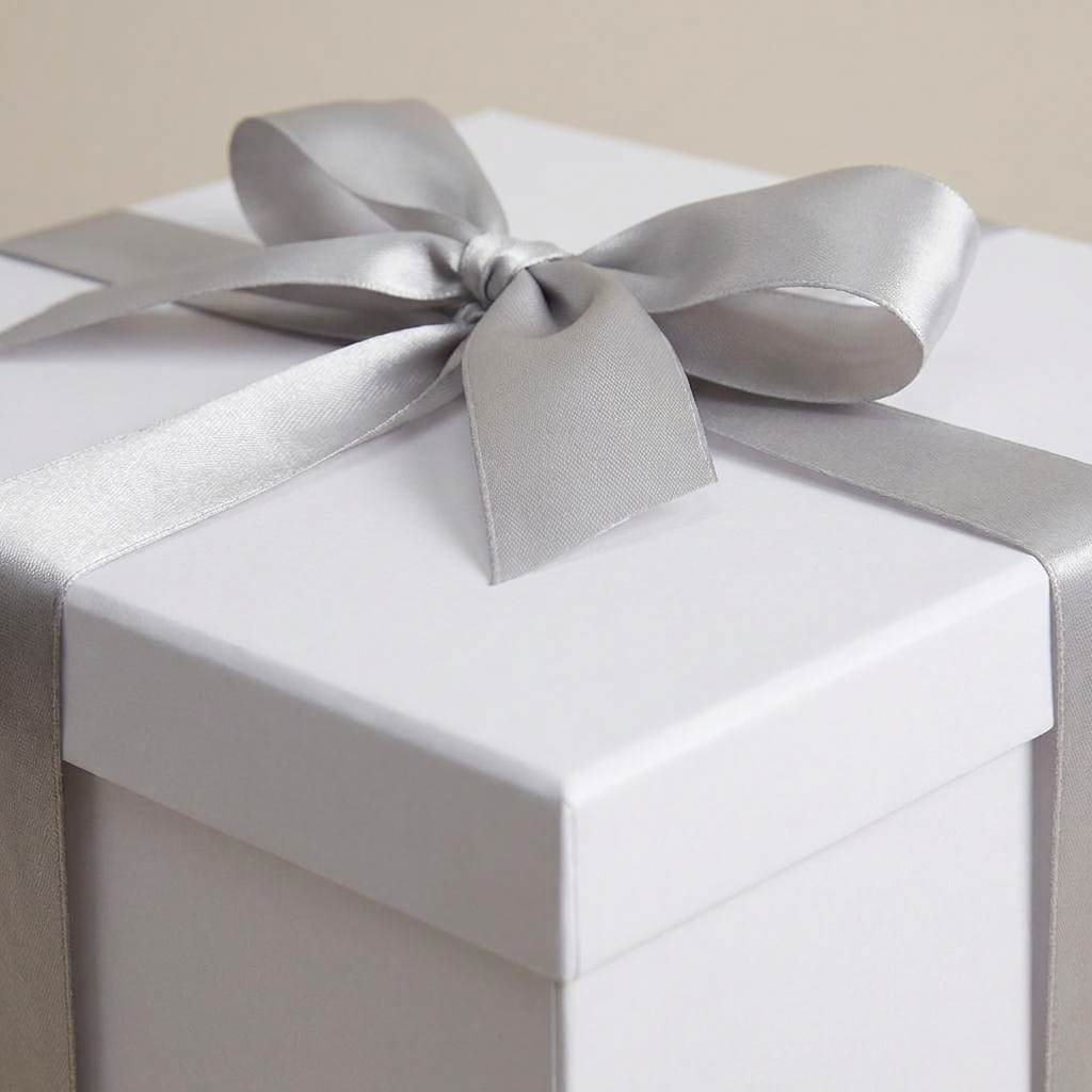Close-up of silver ribbon bow on white gift box