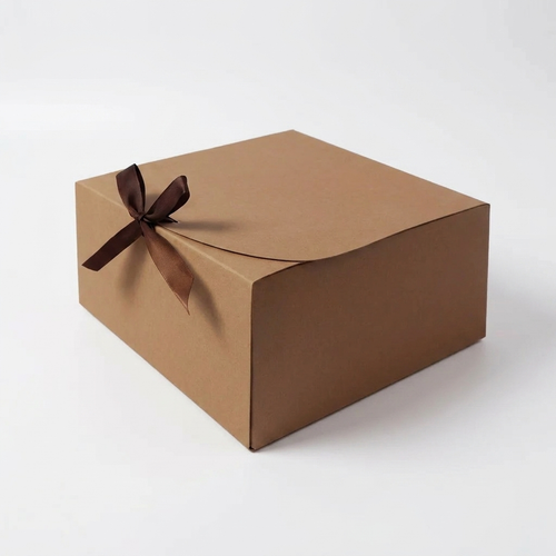 Brown kraft gift box with ribbon bow on white background