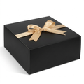 Large black gift box with gold ribbon bow on white background