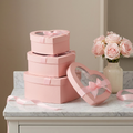 Pink heart window boxes on marble vanity with roses