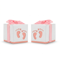 White baby shower favor boxes with pink footprint cut-out and ribbon