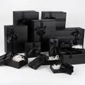 Set of black gift boxes in assorted sizes with black ribbon bows