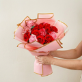 Rose bouquet wrapped in pink gold-edge floral paper