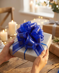 Royal blue pull bow on a present held in hands