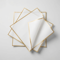 White gold-edge floral wrapping paper sheets on light background