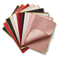 Assorted gold-edge floral wrapping paper sheets on white background