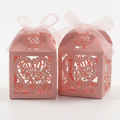 Pink laser-cut heart favor boxes with ribbons