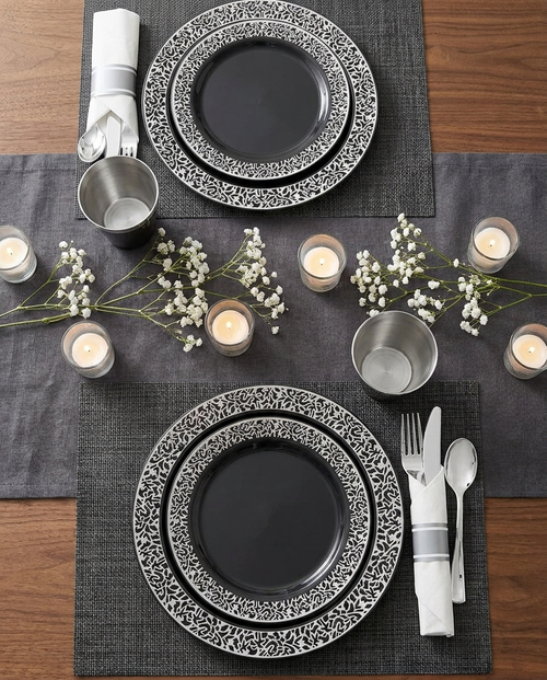 Overhead flat-lay of black silver dinnerware table setting for two