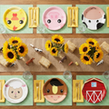 Farm Fete 60-piece farm animal party plates styled birthday tablescape with sunflowers and burlap runner