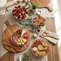 Styled buffet grazing scene with clear serving bowls filled with fruit, nuts, and snacks on a linen-covered table