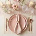 Elegant blush pink dinnerware table setting with rose gold cutlery, crystal glassware, baby's breath florals, and ivory linen runner