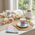 Floral paper tea cups with saucers — 45-degree styled tablescape with gold cutlery, spring florals, linen runner and ceramic teapot