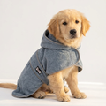 Cute dog wearing a grey absorbent terry cloth pet drying robe after bath
