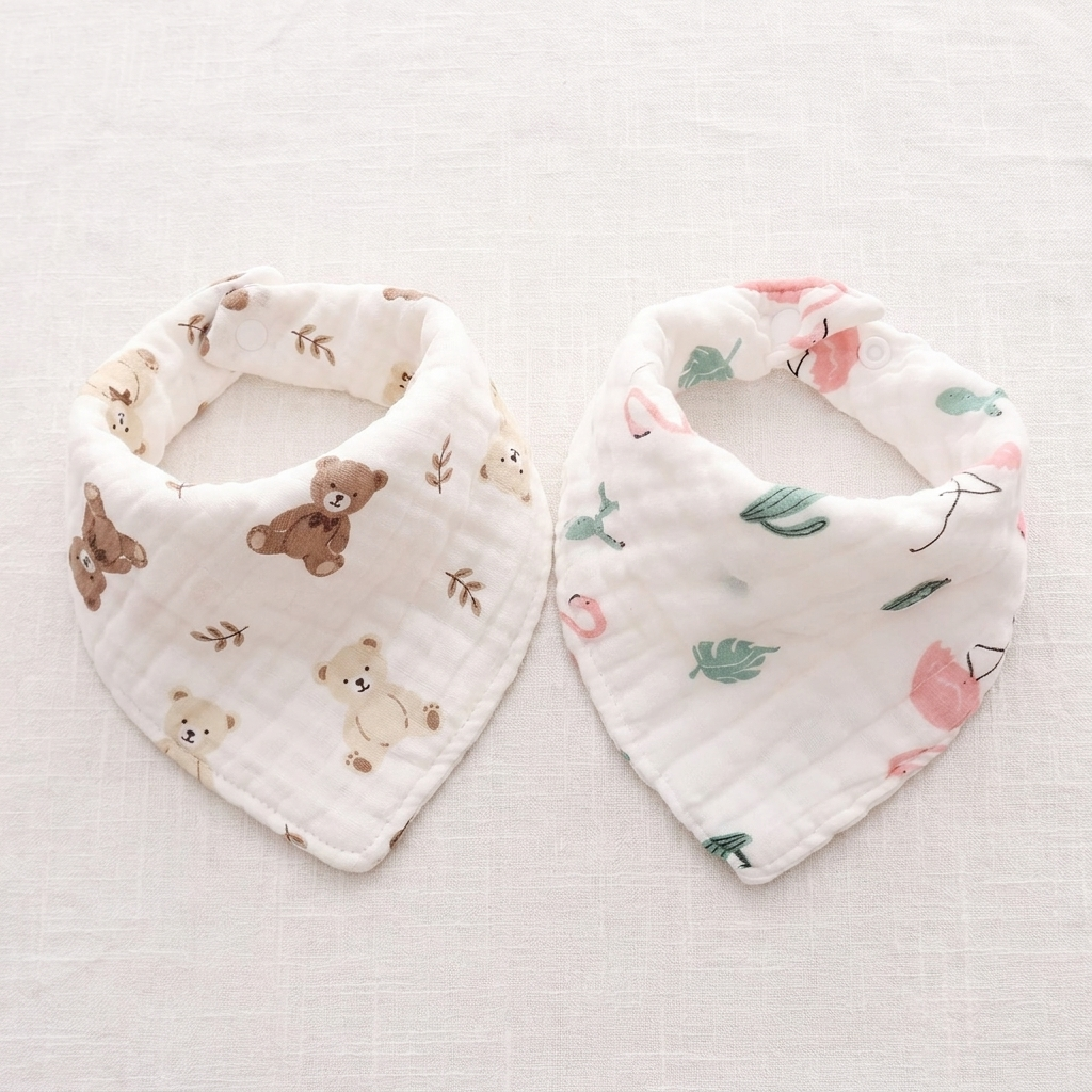 Bear design and green leaf bird design cotton triangle baby bibs laid flat side by side