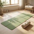 Foldable travel yoga mat laid flat in bright minimalist home, showing compact portable design