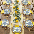 40-piece lemon birthday party tableware set styled as elegant summer citrus tablescape with lemon plates, yellow napkins, gold cutlery and fresh lemon accents