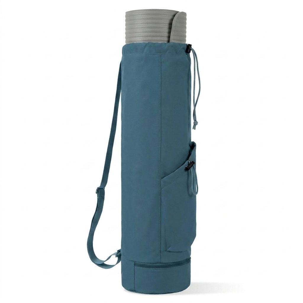 Blue yoga mat bag upright on white surface with yoga mat peeking out of the drawstring top