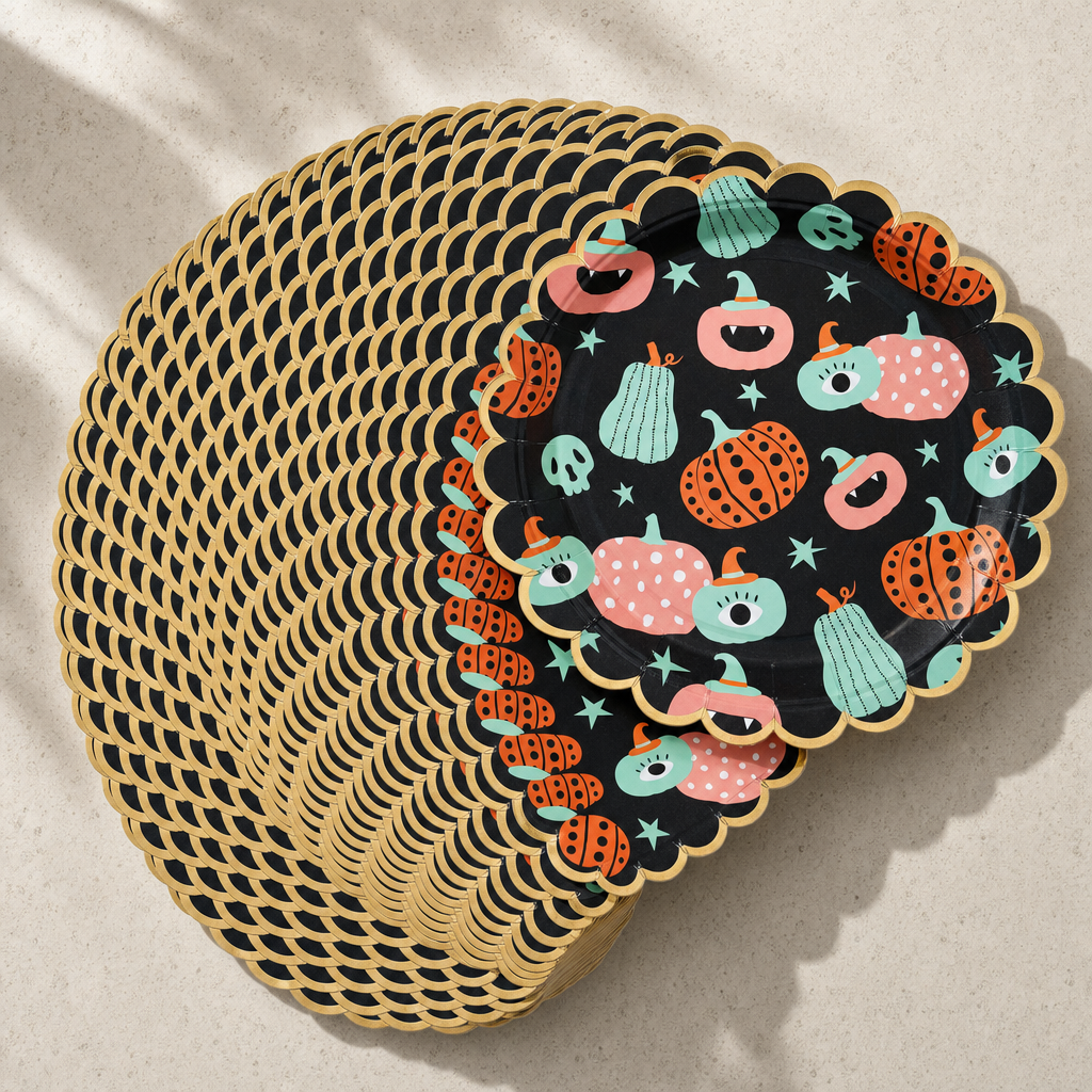 A deep stack of the Halloween paper plates fanned in an arc, showing the gold scalloped edges repeating