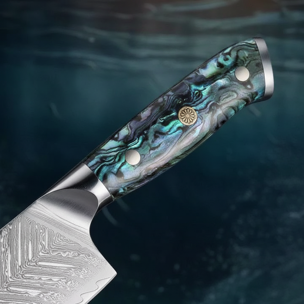 Close-up of the iridescent abalone-resin handle and Damascus wave blade pattern