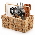 Loaded woven utensil caddy on white. Utensils, napkins and styling props not included. AI-generated product visualization.