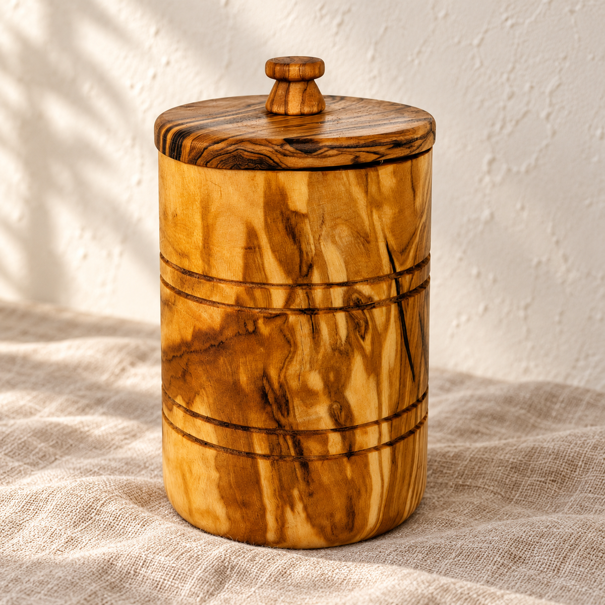 New close view of the closed wood keeper lid and two pairs of grooves; linen is a styling prop, not included.