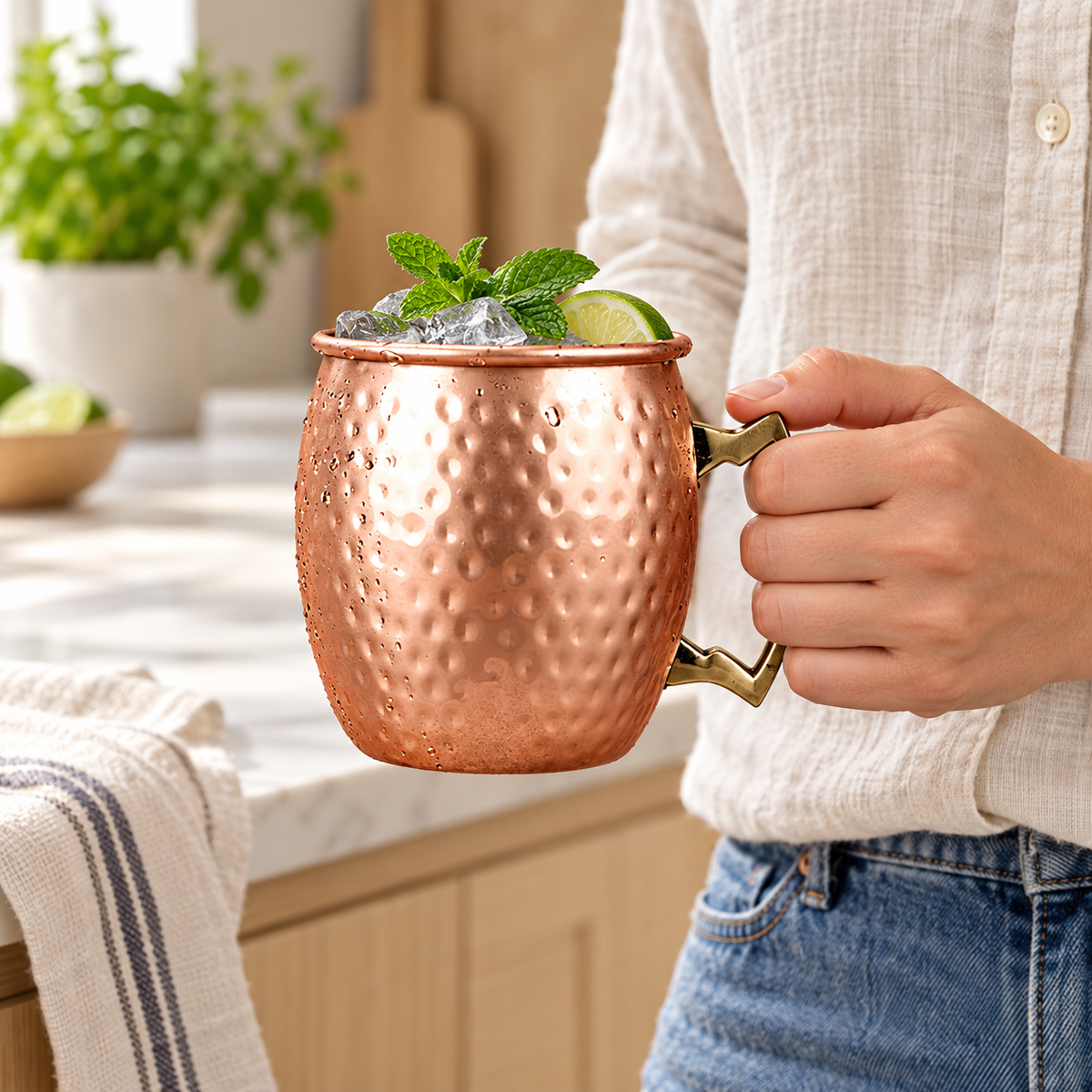 Gold550ML copper-toned hammered mug held for scale. Single mug; garnish is not included.