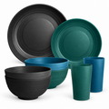 White-background sample assortment of matte wheat-straw and plastic plates, bowls and tumblers in charcoal, teal and petrol blue.