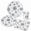 White-background sample of the silver snowflake paper tableware: two plate sizes, tapered cup and square napkin.